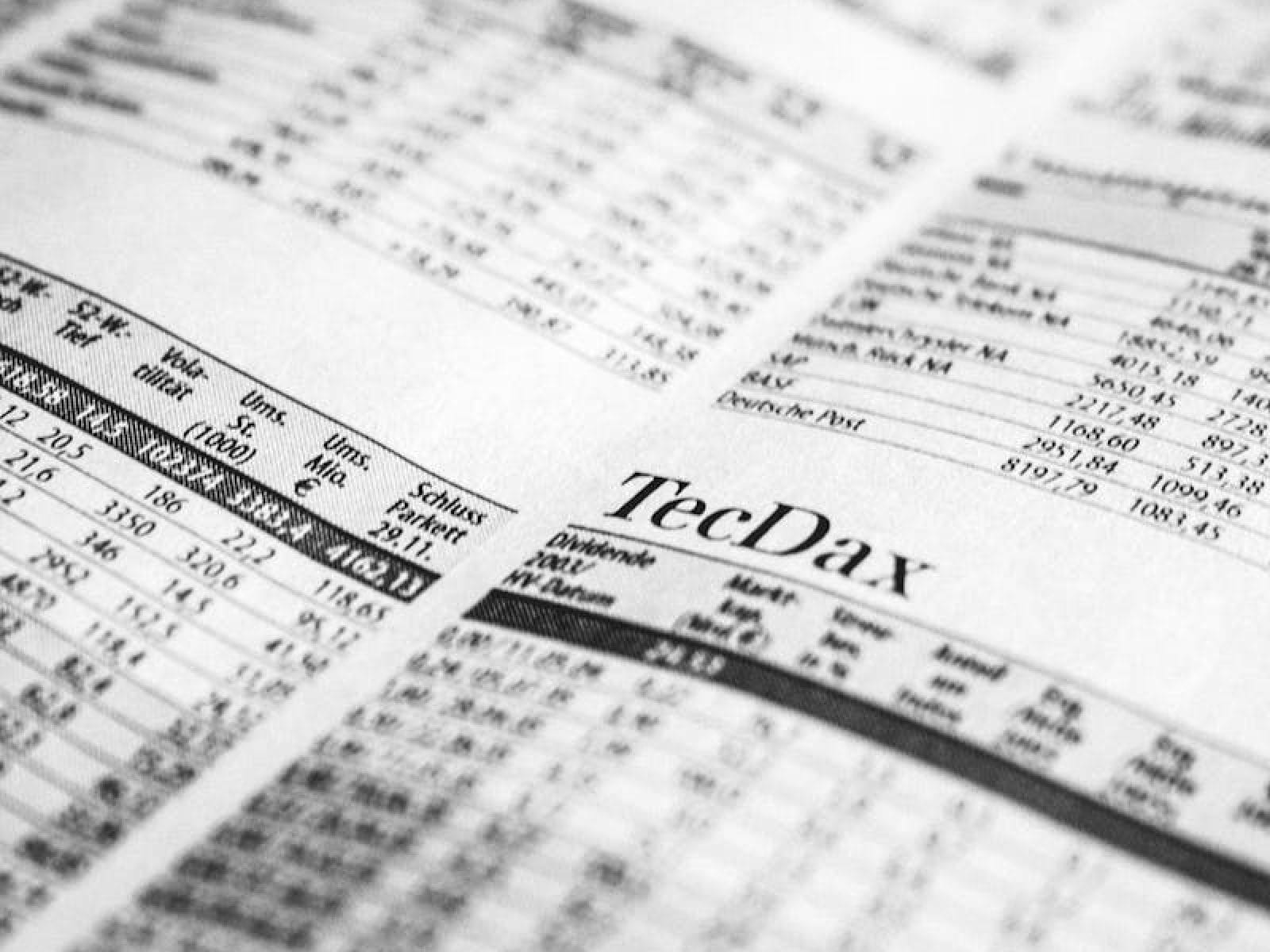 Close-up of a printed stock market report in black and white, highlighting stock prices.