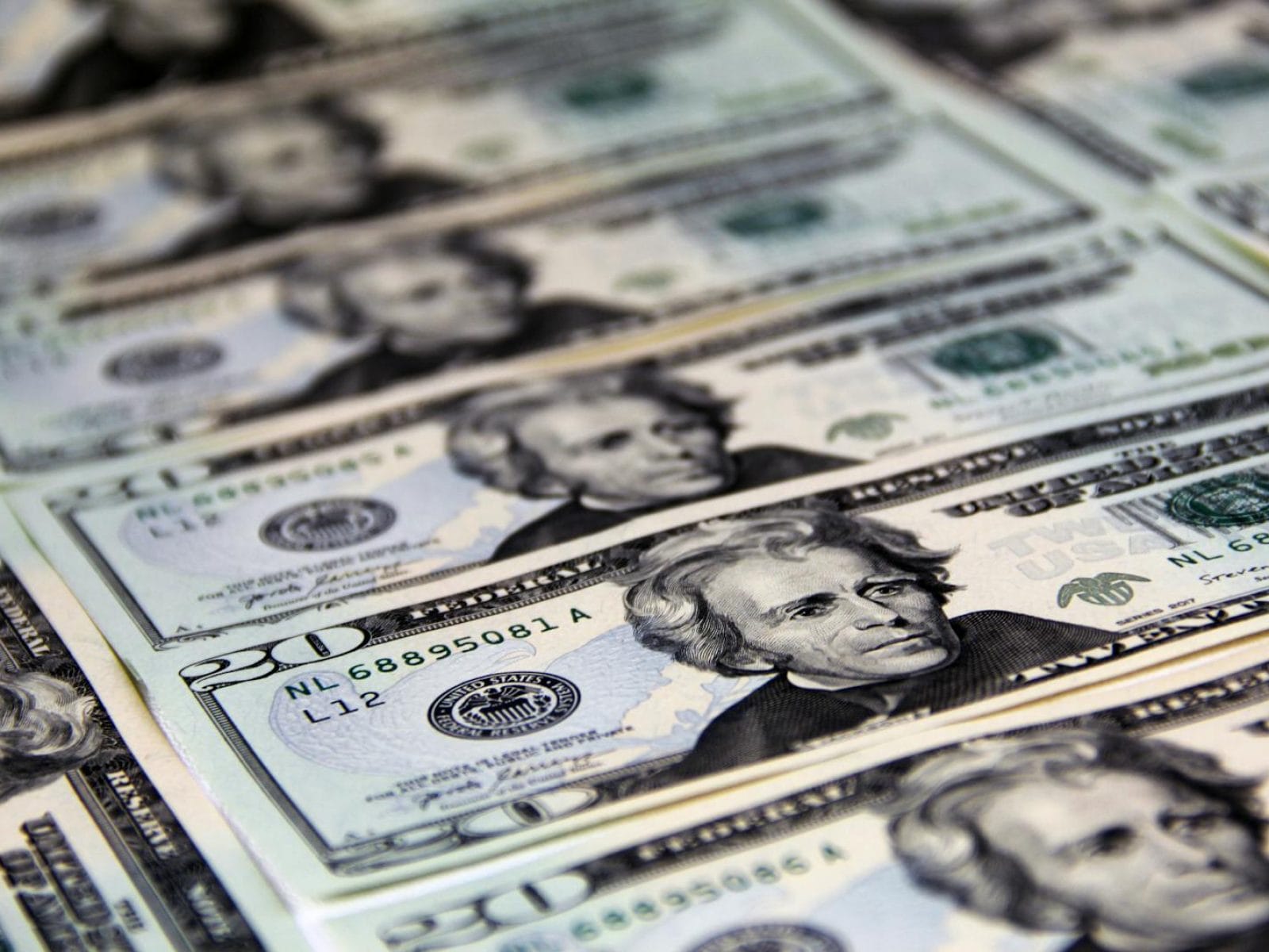 Close-up of crisp US twenty dollar bills arranged in a pattern. Ideal for finance-related visuals.