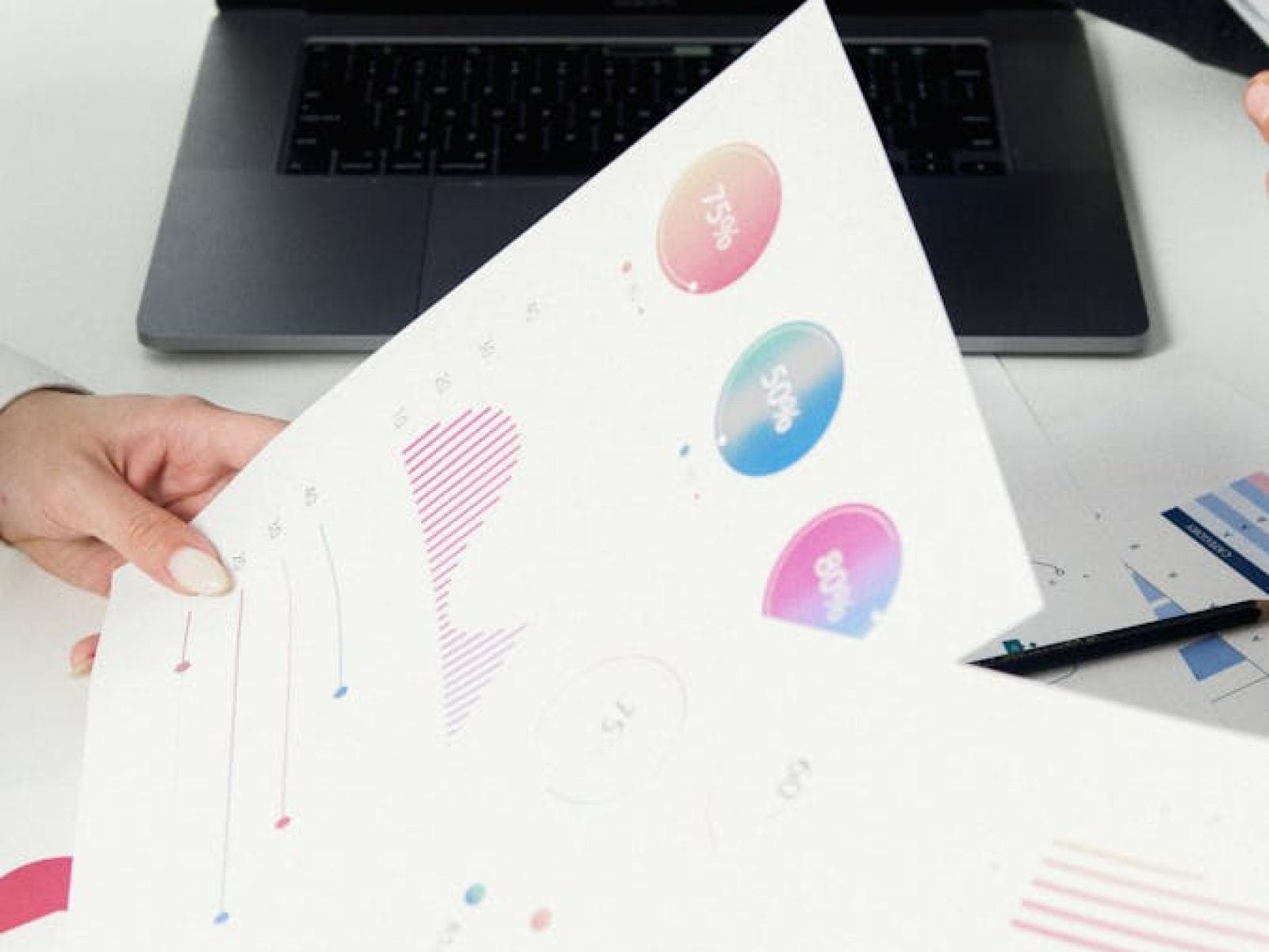 Business professionals reviewing data charts and graphs on laptop.