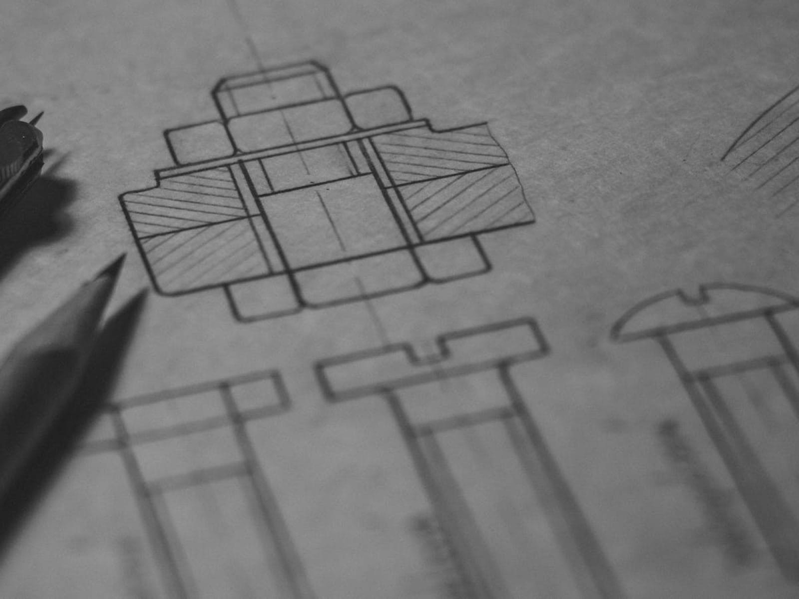 Detailed technical blueprint with pencil and compass illustrating engineering design concepts.