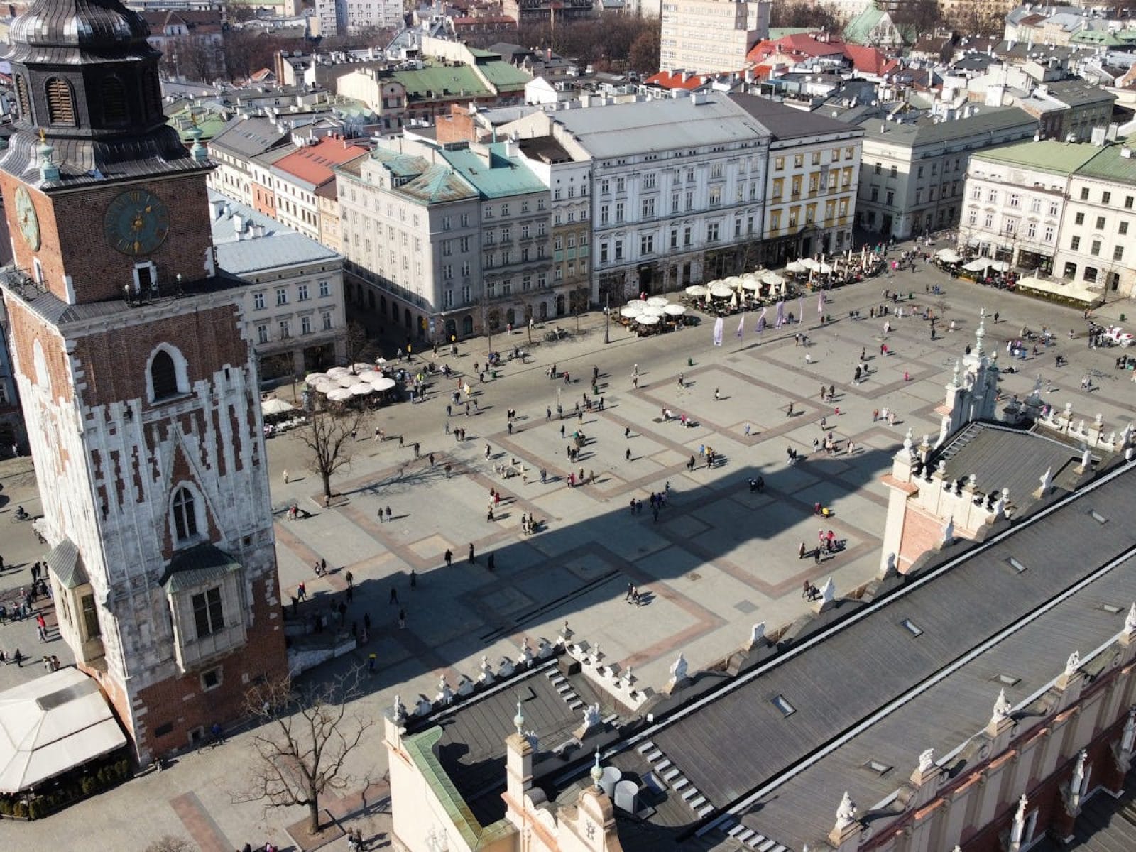 Aerial photo of Kraków's Market Square showcasing the famous Town Hall Tower and surrounding architecture.